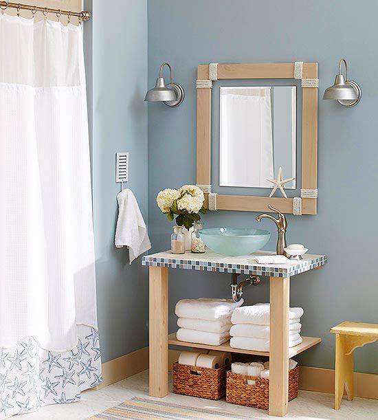 A glass basin in a bathroom below a wooden-framed mirror